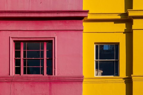 Colourful building facades in pink and yellow, Portobello Road, Notting Hill, London, England,