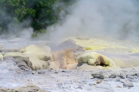 Yellowish sulphur deposits on volcanic formations with rising steam, Te Puia, Whakarewarewa,