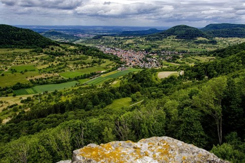 Wide view over the Neidlingen valley with a small village and surrounding hills, Neidlingen