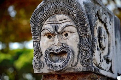 Ancient stone sculpture, stone carving of a mask, Roman theatre, ancient port city of Rome,