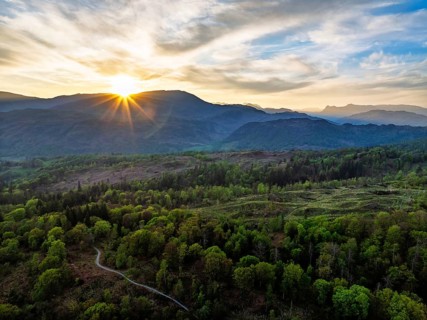 Sunset over Mountains and Coniston Water from drone, Lake District National Park, Cumbria, England,