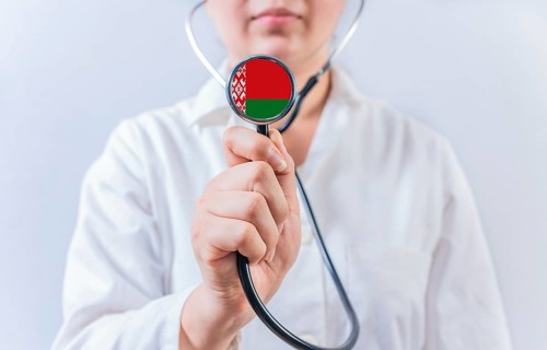 Female doctor holding stethoscope with Belarus flag. National health system of Belarus