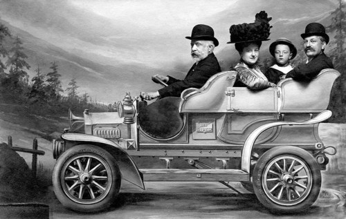 Car journey family, 1910s, family in an old car with hats, black and white photo with nostalgic