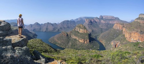 Hiker enjoying panorama, Blyde River Canyon with summit Three Rondawels, view of canyon with river