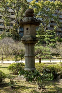 Toro stone lantern in Shukkei-en, historical Japanese strolling garden, Japanese garden, green