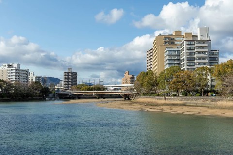 High-rise buildings and bridge over the Kyobashi-gawa River in spring, Naka-ku, Hiroshima, Japan