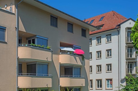 Grey-yellow facades with green concrete balconies and sunshades, Dornbirn, Vorarlberg, Austria