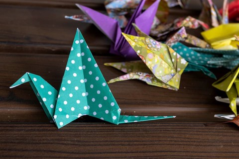 Colourful origami cranes made of paper as a sign of peace in the Peace Park, close-up, landmark,