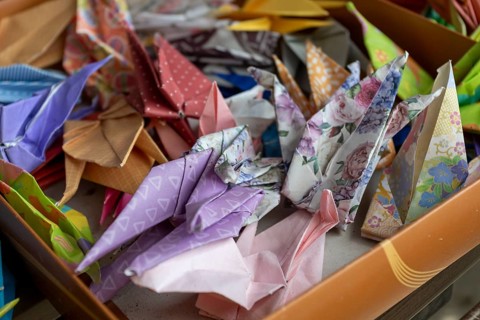 Colourful origami cranes made of paper as a sign of peace in the Peace Park, close-up, background