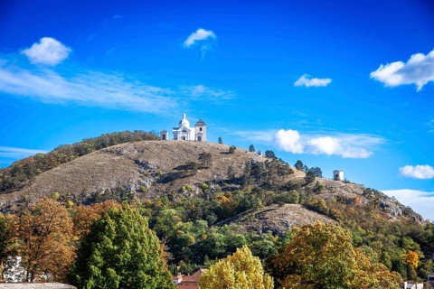 A chapel on a hill with soft autumn colours under a clear blue sky, Mikulov Nikolsburg Czech