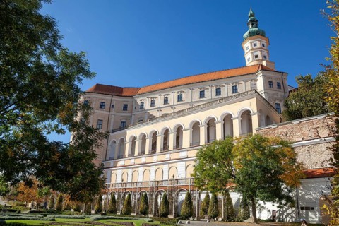 A large castle with arches and windows rises majestically under a cloudless sky, Mikulov Nikolsburg
