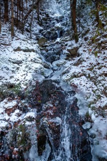 Frozen waterfall in the forest with snow and ice structures, Kamptal Waldviertel Austria