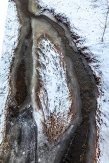 Aerial view of a partially frozen stream surrounded by snow, Kamptal Waldviertel Austria
