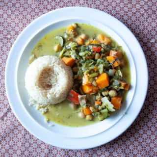 Rice served with vegetable curry in a green sauce on a white plate, Lower Austria Austria