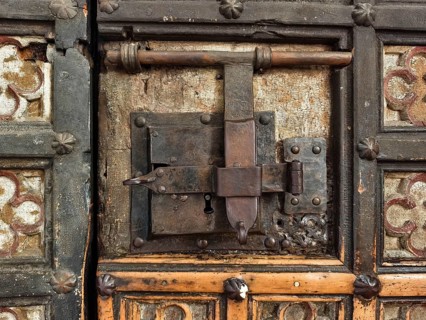 An old, rustic lock system on a wooden and decorated door, Lower Austria Austria