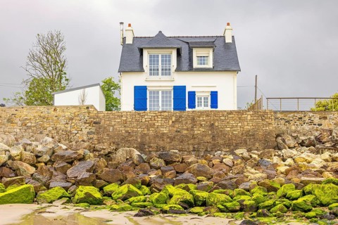 Cute residential house by the beach on a stone pier, Morgat, Crozon peninsula, Bretagne, France