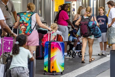 Stuttgart main station. Group of travellers on the platform with colourful suitcases. Stuttgart,