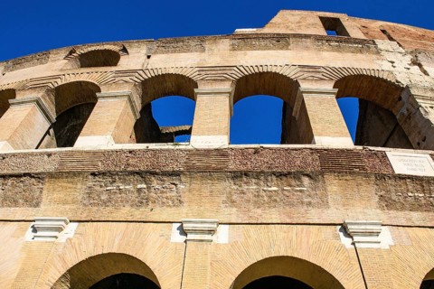 Steep view upwards to partially restored façade Exterior façade with large arched windows Brick