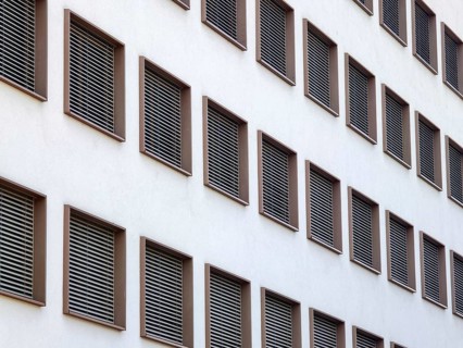 Modern building view with regular window arrangements and ventilation grilles in minimalist
