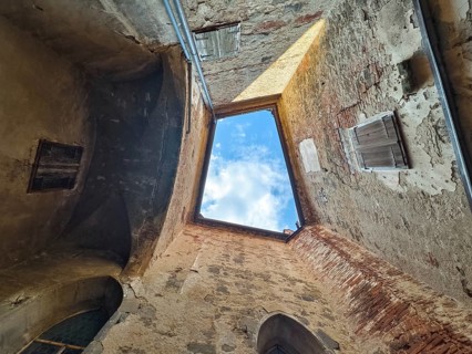 View through an open roof of blue sky with clouds surrounded by old stone walls Riegersburgs Styria