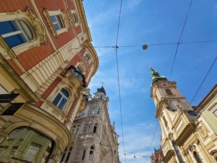 Historic buildings in an urban setting, spanned by a blue sky Herz Jesu Kirche Graz Styria Austria