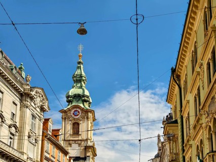 Historic architecture on a busy street with visible power lines Herz Jesu Kirche Graz Styria