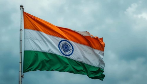 The Indian flag waves proudly against a cloudy sky, symbolizing the nation's independence and