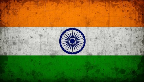 A weathered, vintage-style image of the Indian flag, featuring saffron, white, green stripes and