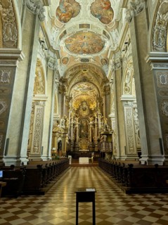 Magnificently decorated baroque interior with altar and ceiling frescoes, atmospheric play of