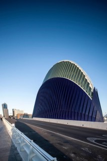 Futuristic blue building in Valencia next to a street under a clear sky