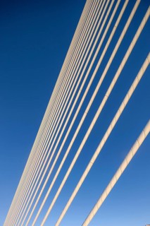 Close-up of cables of a bridge against a clear blue sky