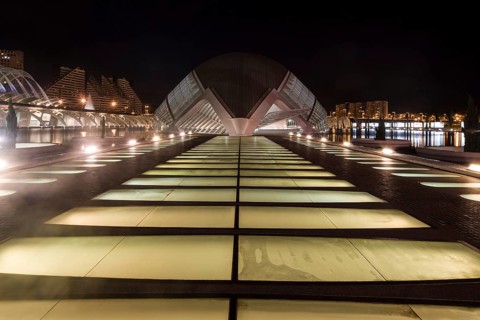 Illuminated modern architecture at night in Valencia with symmetrical design