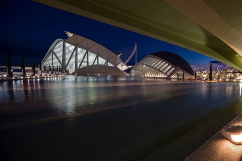 Valencia Spain Illuminated modern architecture with water at night in Valencia City of Arts and