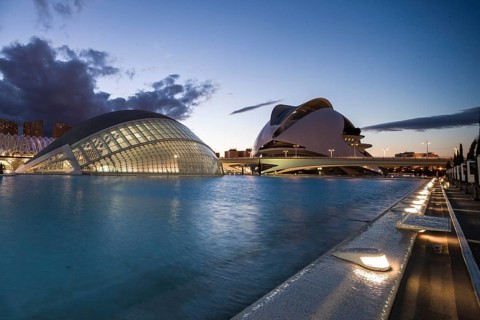 Valencia Spain Large modern building at sunset with illuminated sky and water City of Arts and