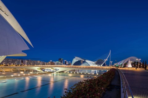 Valencia Spain Modern architecture at night with illuminated bridge under a clear blue sky