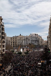 Large crowd in a city in front of tall buildings and a slightly cloudy sky MascletÃ¡ de Fallas