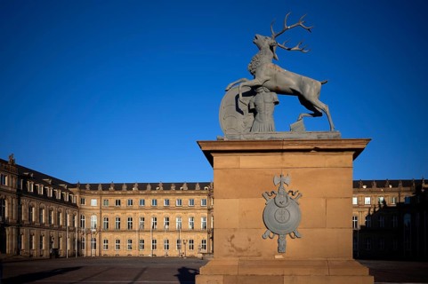 Heraldic animal stag in front of the main wing and cour d'honneur Neues Schloss, Schlossplatz,