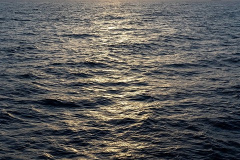 Background image, water surface in evening light, waves in the sea at sunset, Tokyo Bay, Japan