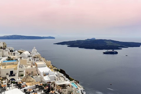 View from the island capital Fira to the uninhabited volcanic island Nea Kameni in the caldera,