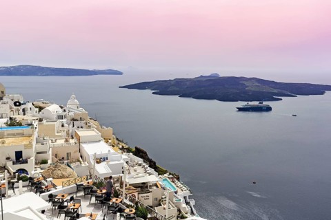 View from the island capital Fira to the uninhabited volcanic island Nea Kameni in the caldera,