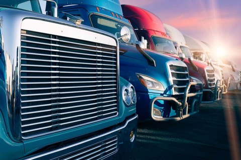 Long haul container trucks carrying commercial cargo on a parking lot ready for delivery