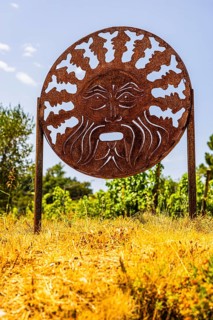 Rusty plaque with motif of the god of wine Bacchus, near the Arrighi winery, Porto Azzurro, Elba