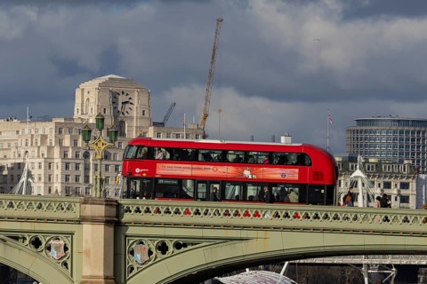 Red double decker bus driving over a bridge, City of London, England, United Kingdom