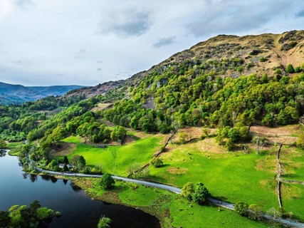 Farms and Mountains over road A591 from a drone, Grasmere Lake, Grasmere, Ambleside, Lake District,