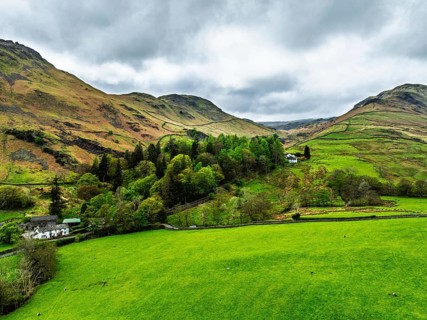 Farms and Mountains over road A591 from a drone, Grasmere Lake, Grasmere, Ambleside, Lake District,