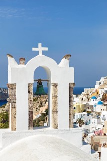 Bell tower of an orthodox church with a view of the village, Oia, Santorini, Cyclades, Greece