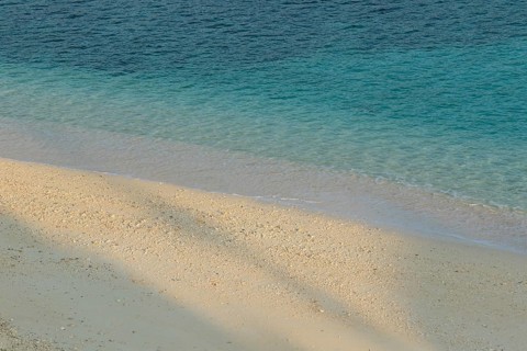 Sunlight, shade, sand and turquoise water at Sesoko-jima beach, Sesoko Island, Motobu, Kunigami