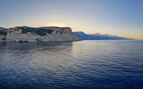 Vibrant seascape sunset with a view to the Pirate Cave in Kemer, Turkey. Beautiful Turkish