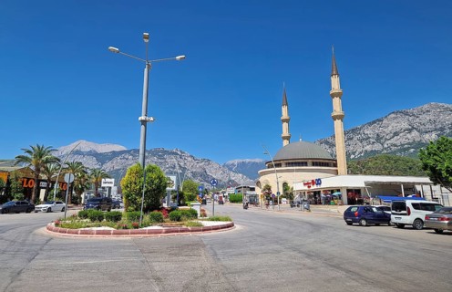 KEMER, TURKEY - JULY 5, 2025 Kemer city centrum view with grand mosque Huzur Camii Dzamija with two