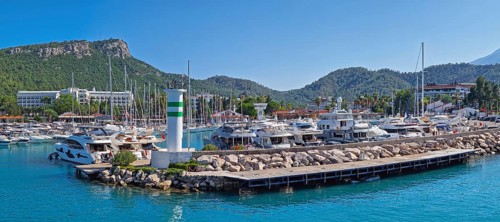 KEMER, TURKEY - JULY 3, 2025 Marina panoramic view with Calis Hill in the background. Rocky pier